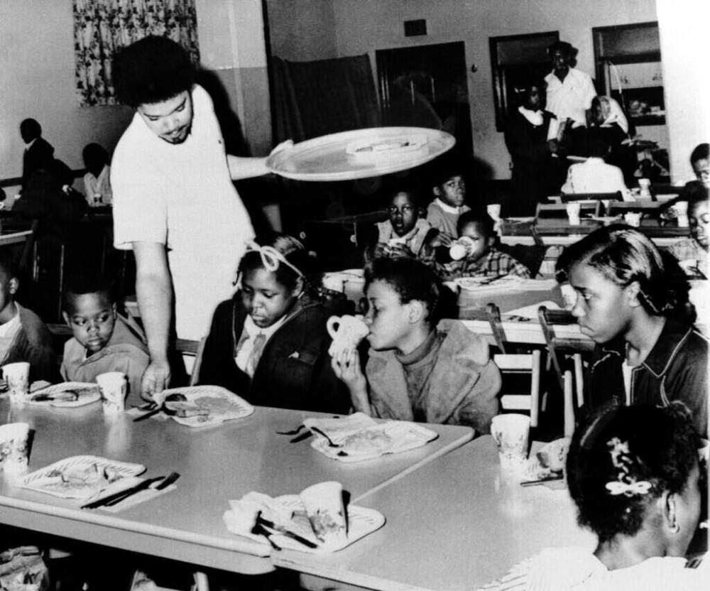 In this April 16, 1969 file photo, Bill Whitfield, member of the Black Panther chapter in Kansas City, serves free breakfast to children before they go to school. (William P. Straeter/AP)