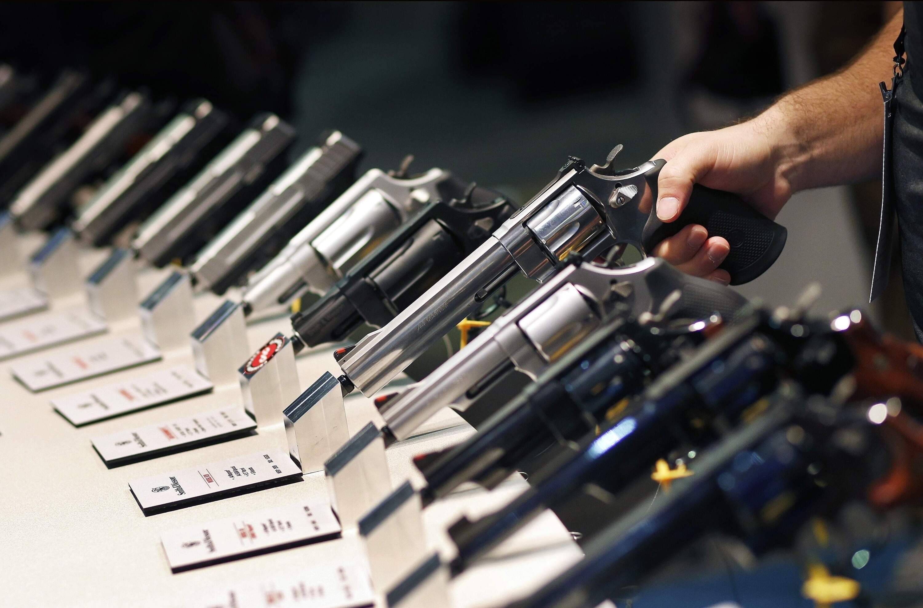 Handguns are displayed at the Smith & Wesson booth at the Shooting, Hunting and Outdoor Trade Show in Las Vegas. (John Locher/AP)