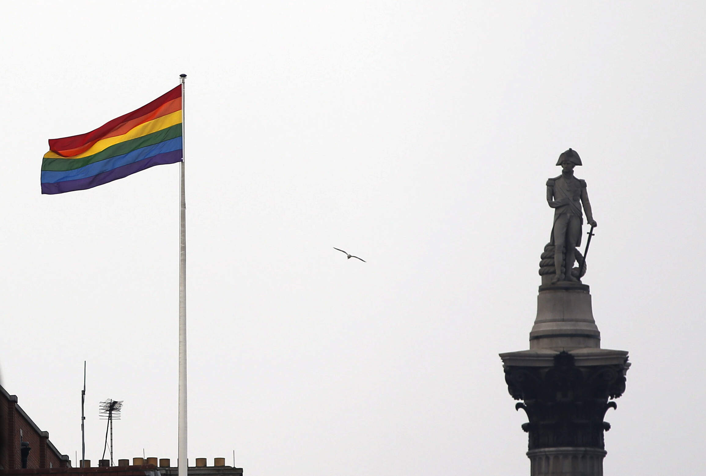 The rainbow flag, a symbol of lesbian, gay, bisexual, and transgender community, flies over a building next to Nelson's Column monument, right, in Trafalgar Square, central London, Britain. (Lefteris Pitarakis/AP)
