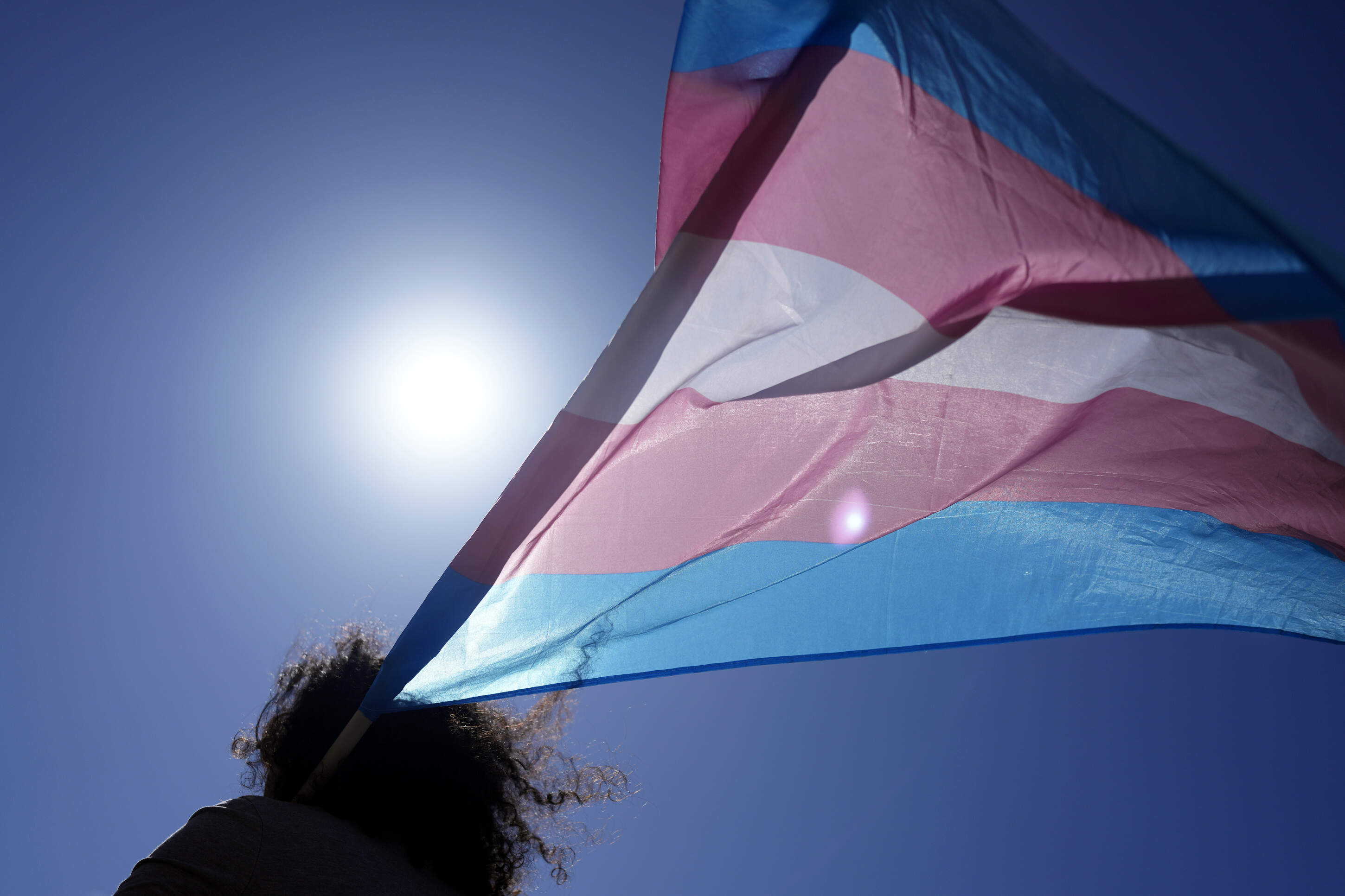 An attendee carries a Transgender flag during a march to celebrate International Transgender Day of Visibility, in Lisbon, Portugal, Sunday, March 31, 2024. (Armando Franca/AP)