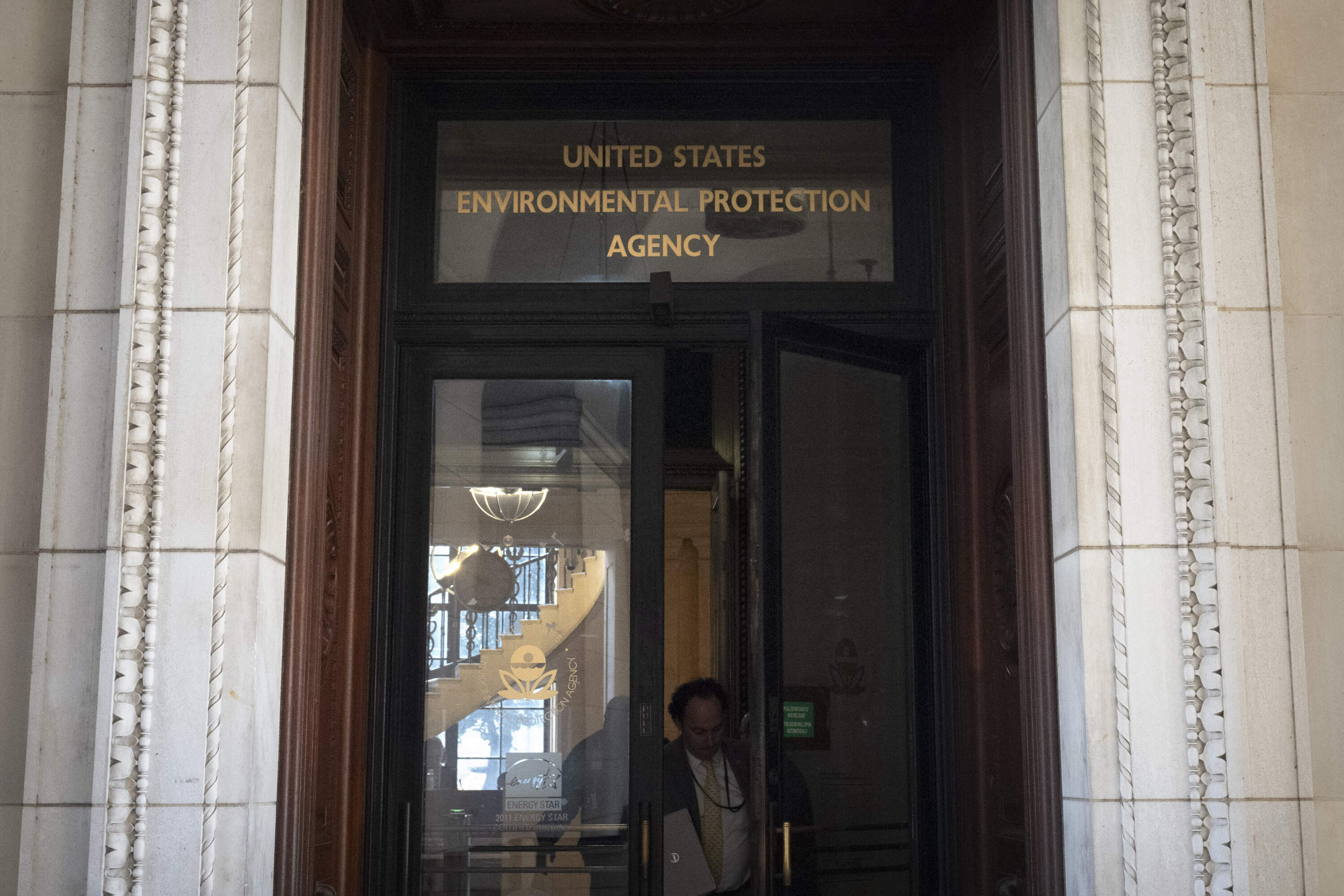 A person exits the headquarters building of the Environmental Protection Agency Wednesday, March 12, 2025, in Washington. (Mark Schiefelbein/AP)