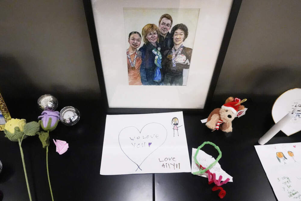 Photographs, flowers and remembrances are displayed at The Skating Club of Boston for the six athletes, coaches and parents who died in the plane crash. (Charles Krupa/AP)