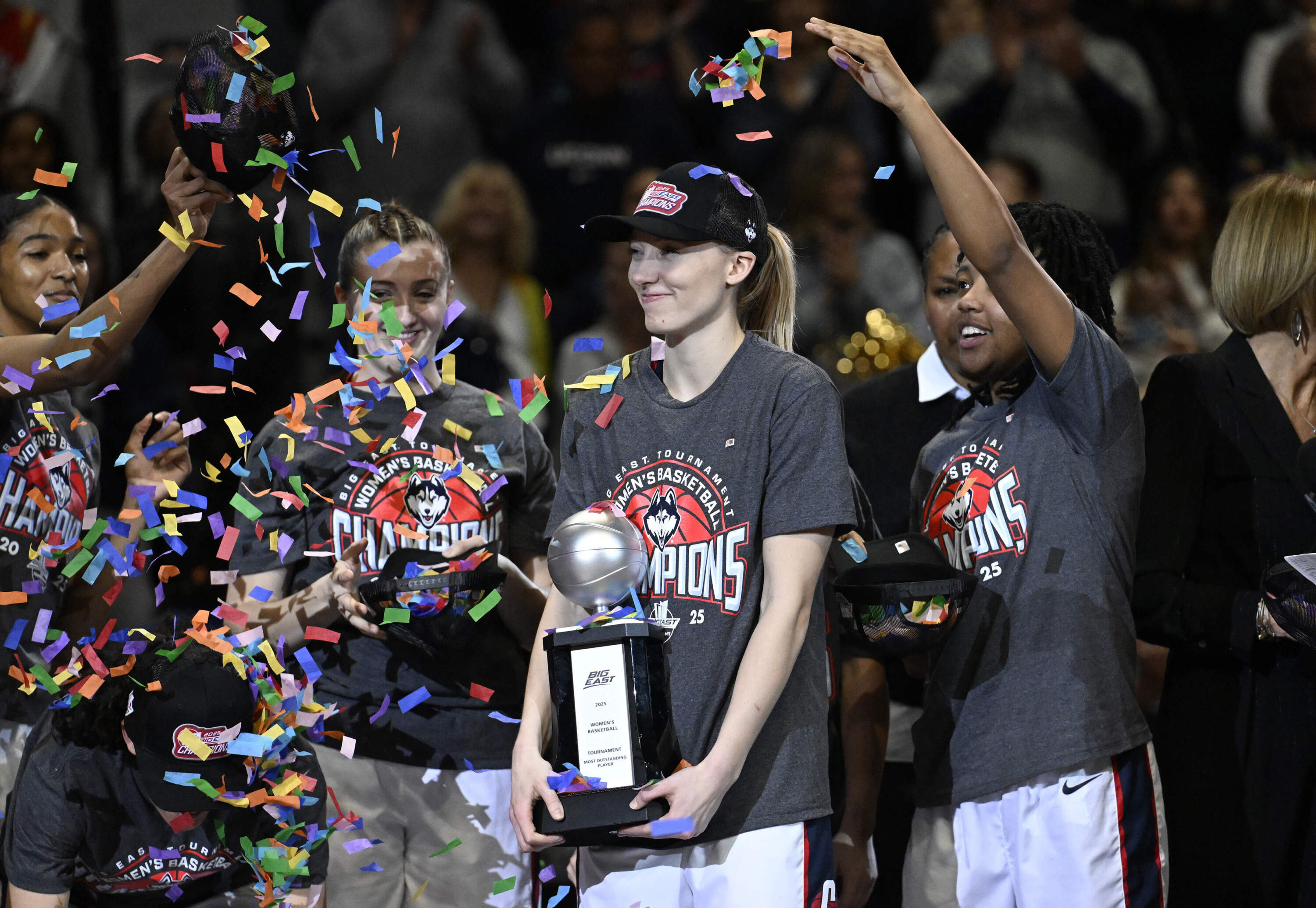 UConn's Paige Bueckers, center, holds the Most Outstanding Player trophy after the school defeated Creighton in an NCAA college basketball finals game of the Big East Conference tournament, Monday, March 10, 2025, in Uncasville, Conn. (Jessica Hill/AP)
