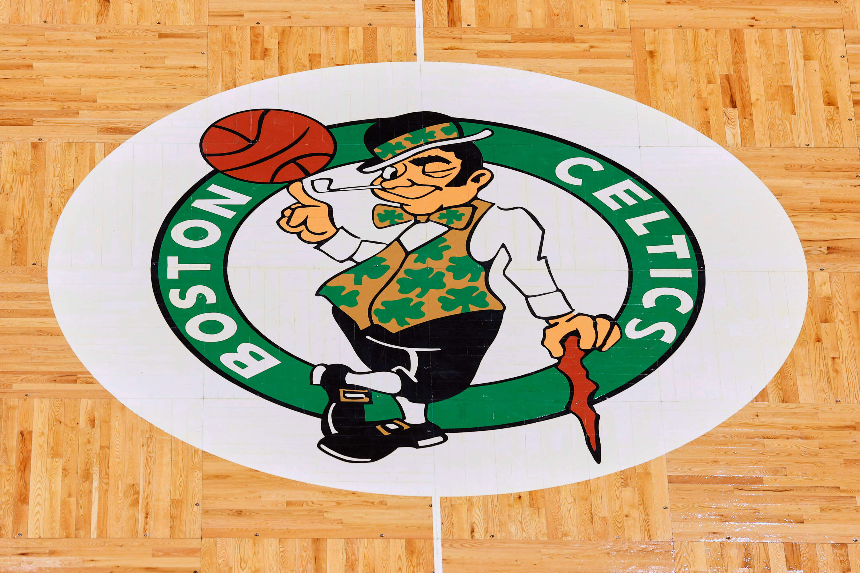 The Boston Celtics logo at center court on the parquet floor before an NBA basketball game. (Winslow Townson/AP)