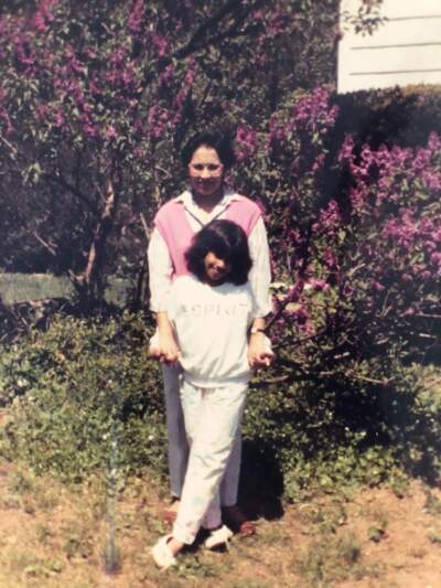 The author and her mother in the mid-1980's, standing beside a lilac bush outside her childhood home. (Courtesy Divya Kumar)
