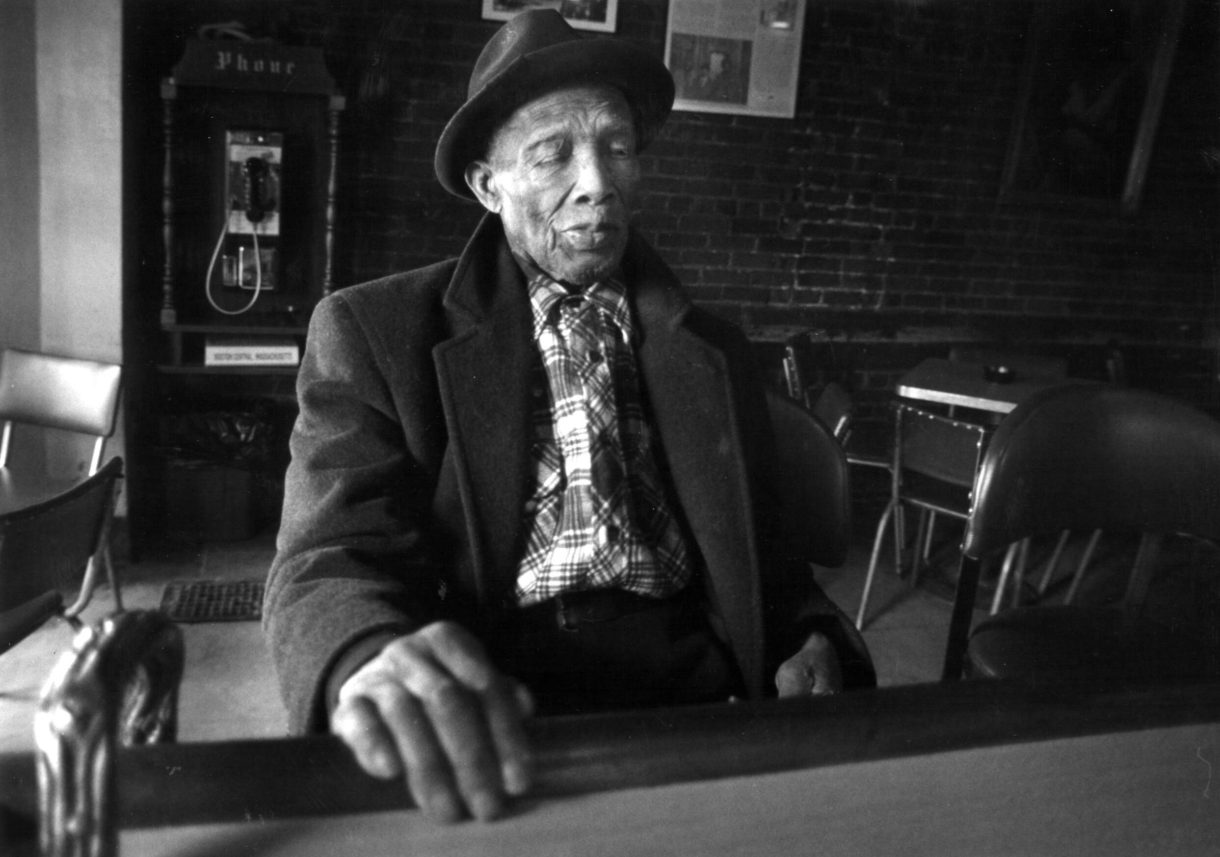 The late Wally's cafe owner, Joseph "Wally" Walcott, sits at his bar in Boston on April 22, 1994. He was 97 years old. His club has been a mecca for musicians and a South End watering hole for half a century. (Jonathan Wiggs/The Boston Globe via Getty Images)