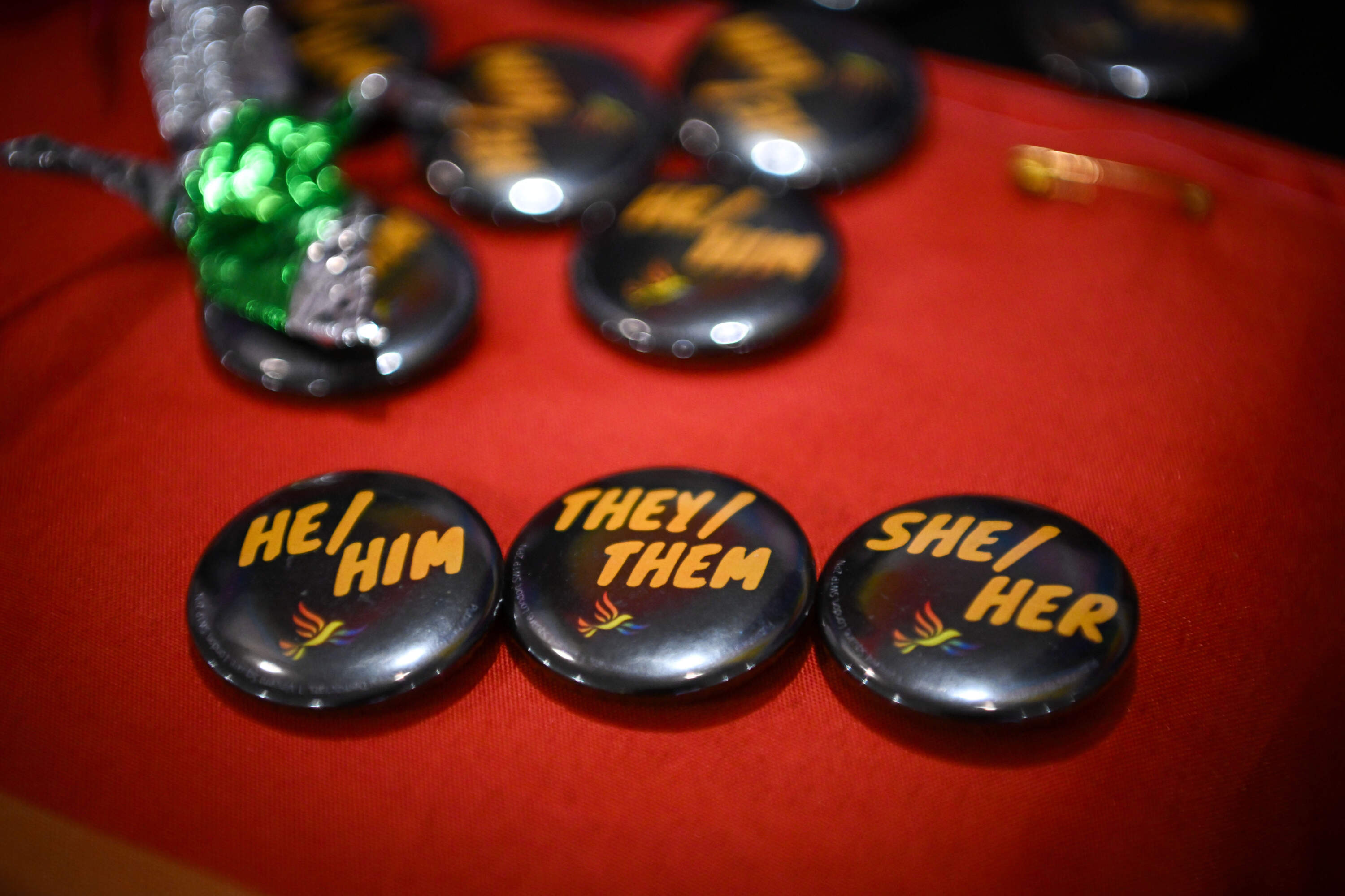 Pronoun badges showing, 'he, him, they, them, she and her are displayed on the LGBT+ stall in the exhibition hall, at Bournemouth International Centre, September 25, 2023. (Finnbarr Webster/Getty Images)