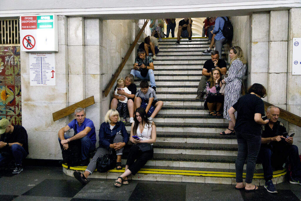 People sit on the steps of an interchange passage at the Khreshchatyk metro station seeking shelter during the Russian drone and missile attack on Ukraine in Kyiv, Ukraine, on August 26, 2024. (Ukrinform/NurPhoto via Getty Images)