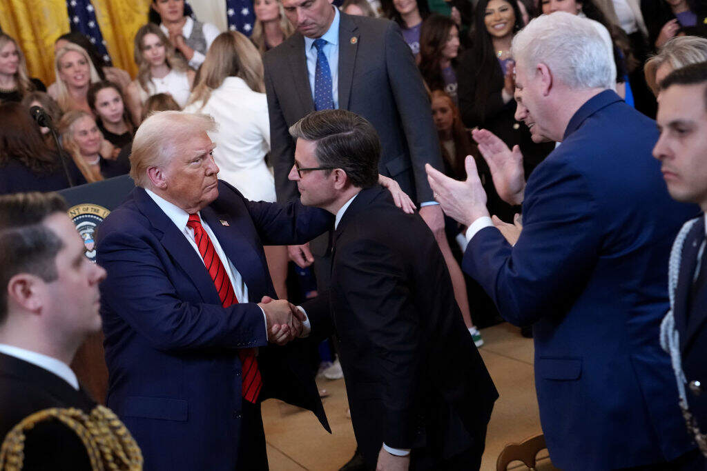 U.S. President Donald Trump shakes hands with Speaker of the House Mike Johnson (R-LA) as House Majority Whip Tom Emmer (R-MN) stands near after signing the “No Men in Women’s Sports” executive order in the East Room at the White House on February 5, 2025 in Washington, DC. (Andrew Harnik/Getty Images)