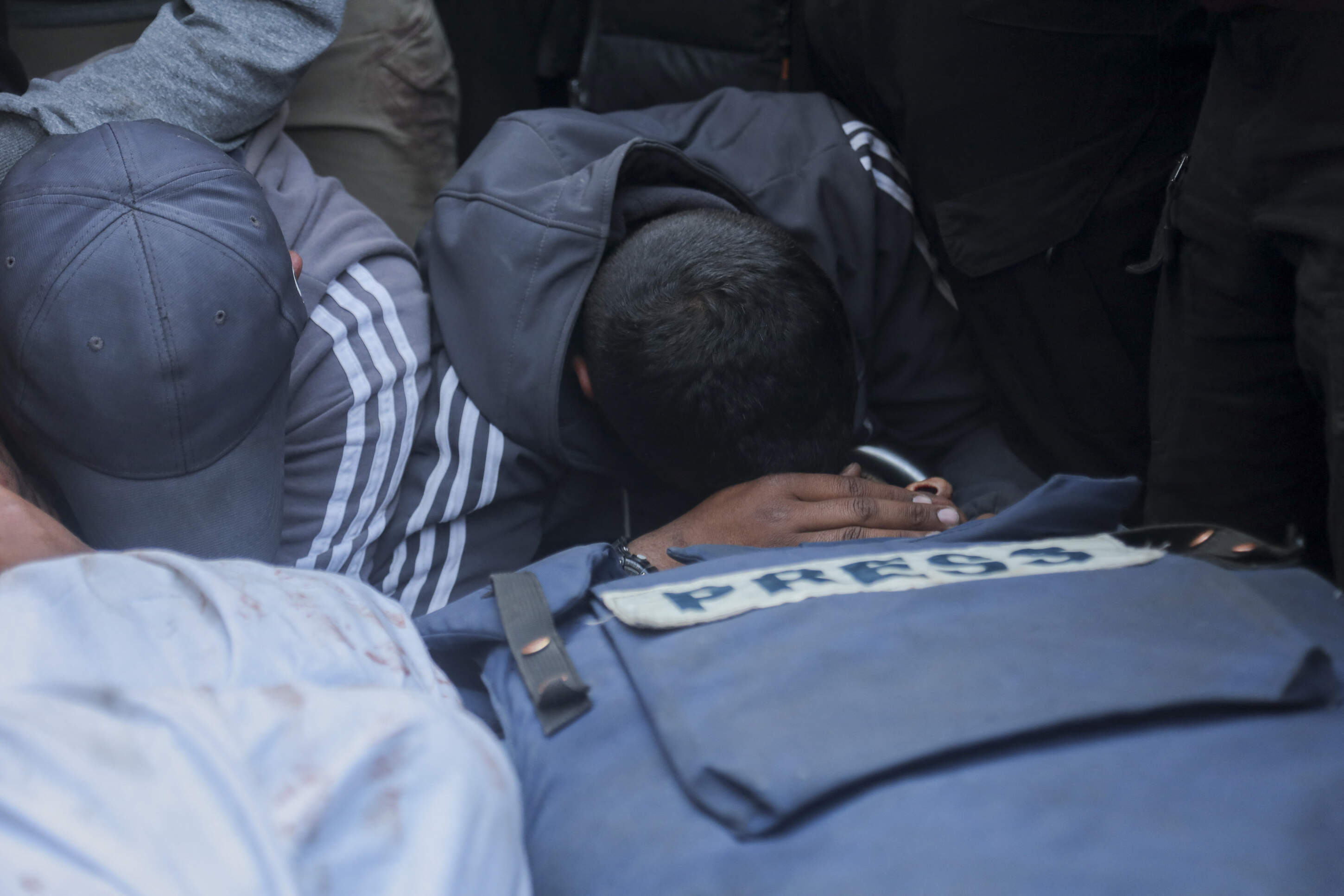 Family and friends mourn over the bodies of Palestine Today journalist Mohammad Mansour (L) and Hossam Shabat (R), a 23-year-old Al Jazeera journalist, who were killed by Israeli army on March 24, 2025 in Gaza Strip, Palestinian territories. Shabat's car was reportedly targeted in Beit Lahiya. (Abood Abosalma/Middle East Images/AFP via Getty Images)