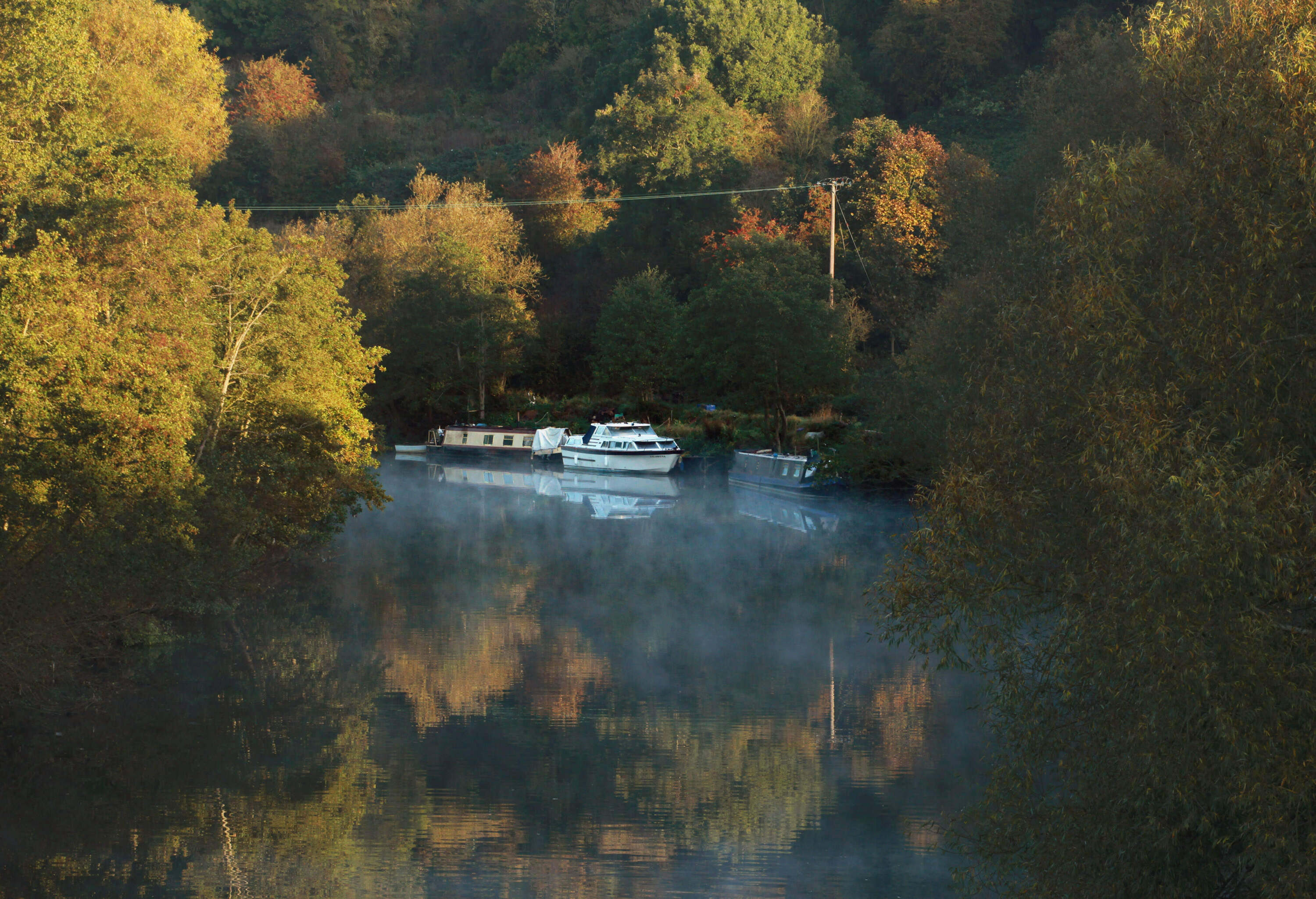 Mist rises on the River Avon below trees that are begining to change colour (Matt Cardy/Getty Images)