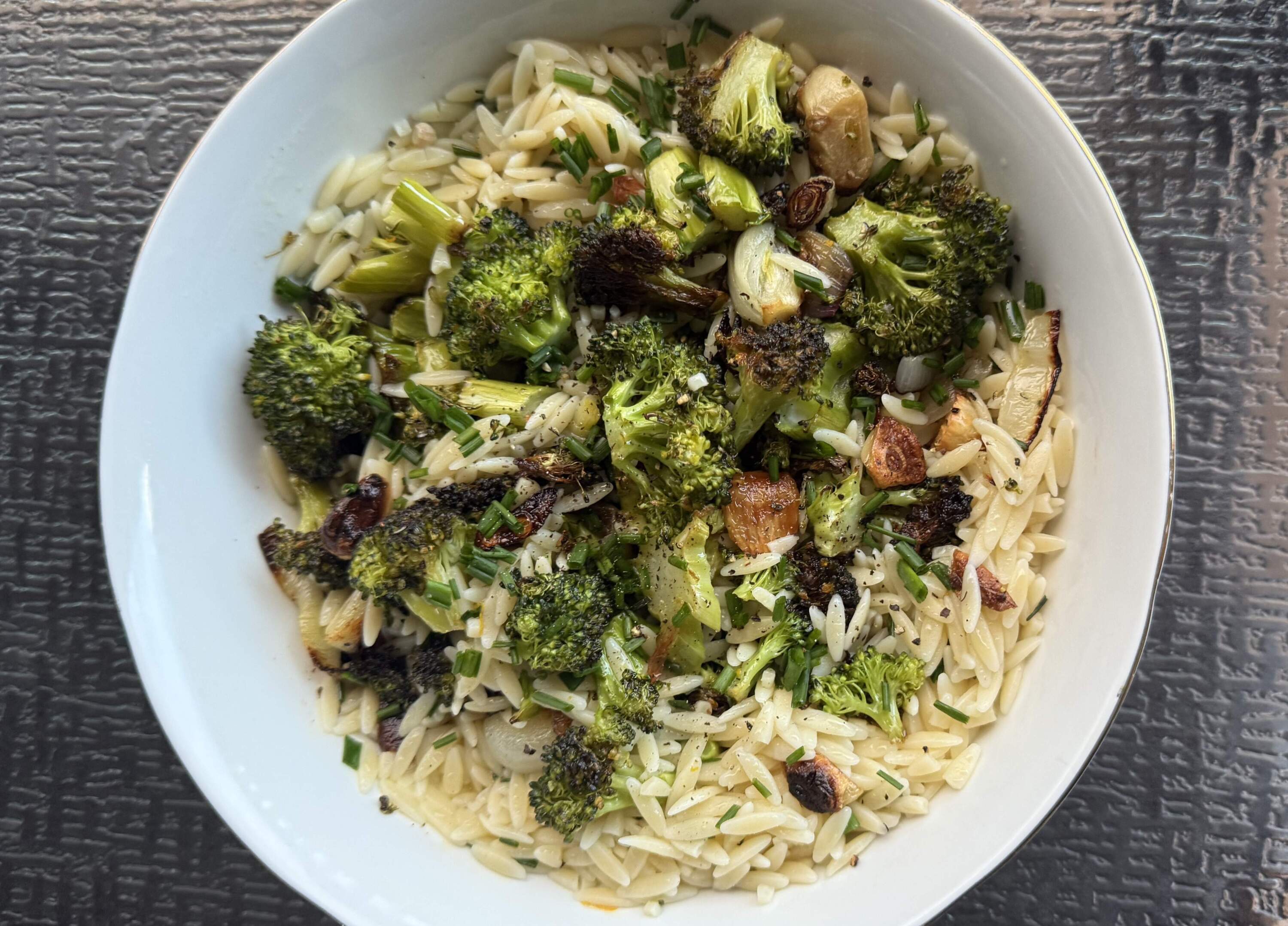 Lemon roasted broccoli and orzo salad with garlic with spring chives. (Kathy Gunst / here & amp; now)