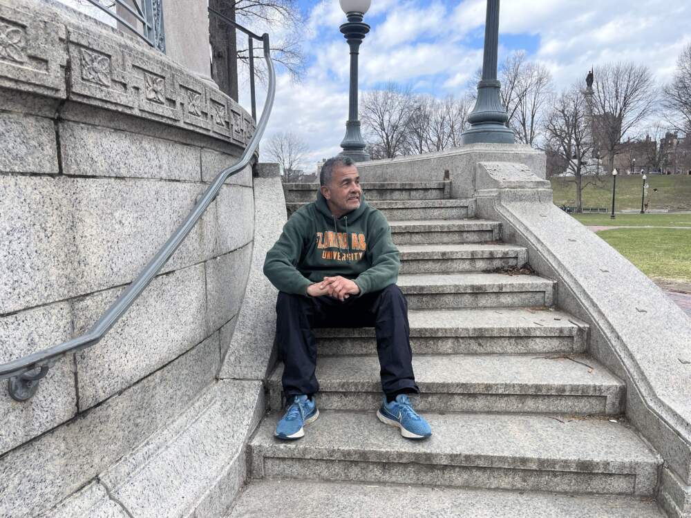 Wayne Lucas sits on the steps of the Parkman Bandstand in the Boston Common. (Arielle Gray/ WBUR)