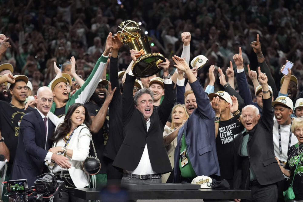 Boston Celtics owner Wyc Grousbeck holds up the Larry O'Brien Championship Trophy after Game 5 of the NBA Finals basketball series against the Dallas Mavericks, Monday, June 17, 2024, in Boston. (Charles Krupa/AP)