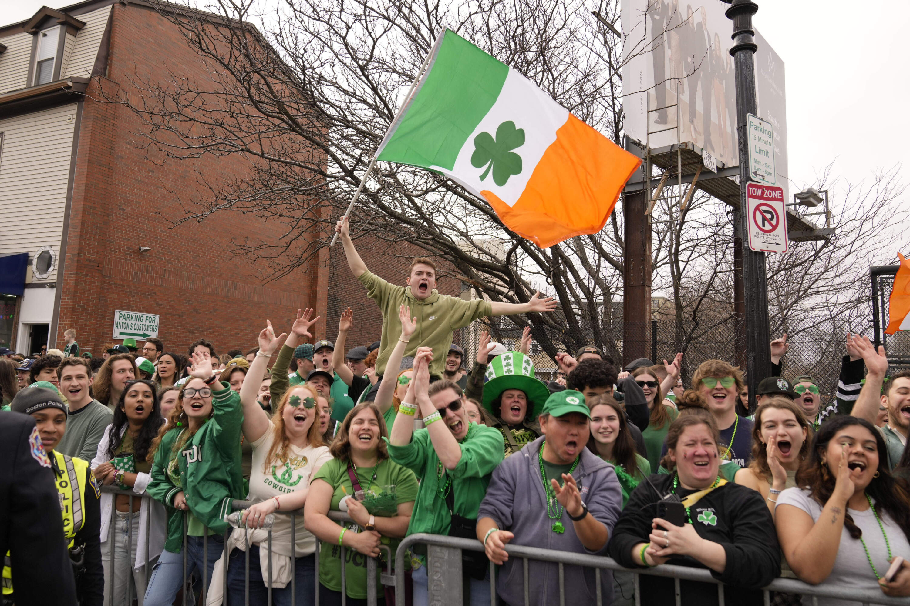 Spectators cheer along the parade route in South Boston. (Robert F. Bukaty/AP)