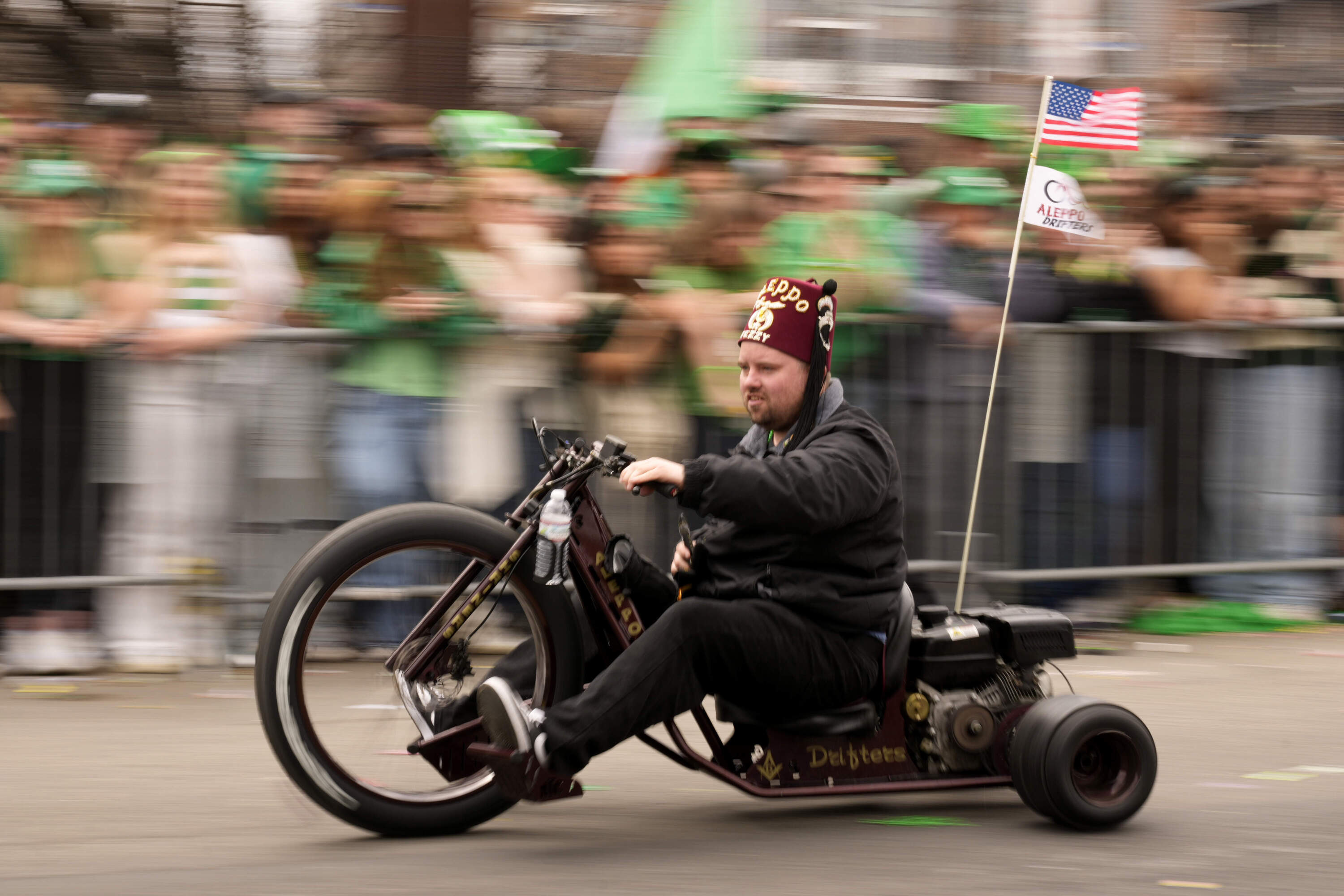 A Shriner motors by the crowd during the St. Patrick's Day parade. (Robert F. Bukaty/AP)