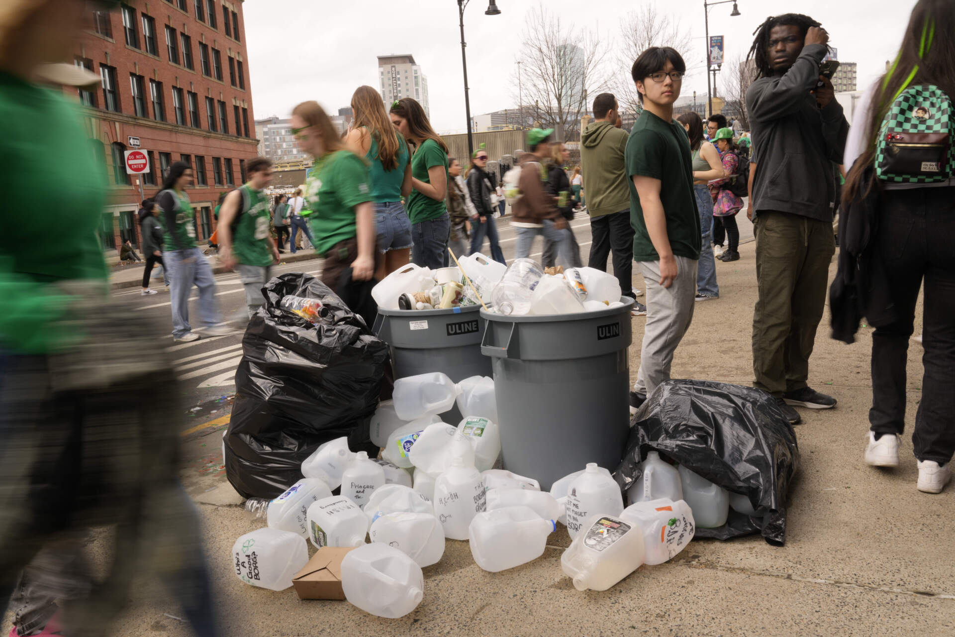 Empty containers that are used for homemade drinks overflow the waste boxes after the parade to St. Patrick's Day on March 16, 2025 (Robert F. Bukaty/AP)