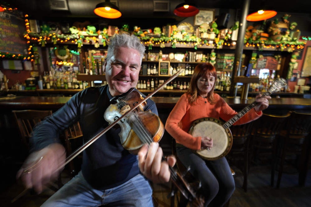 Tommy McCarthy and his wife Louise Costello, owners of the Burren Pub, play an Irish tune, in Somerville, Mass. (Robert F. Bukaty/AP)