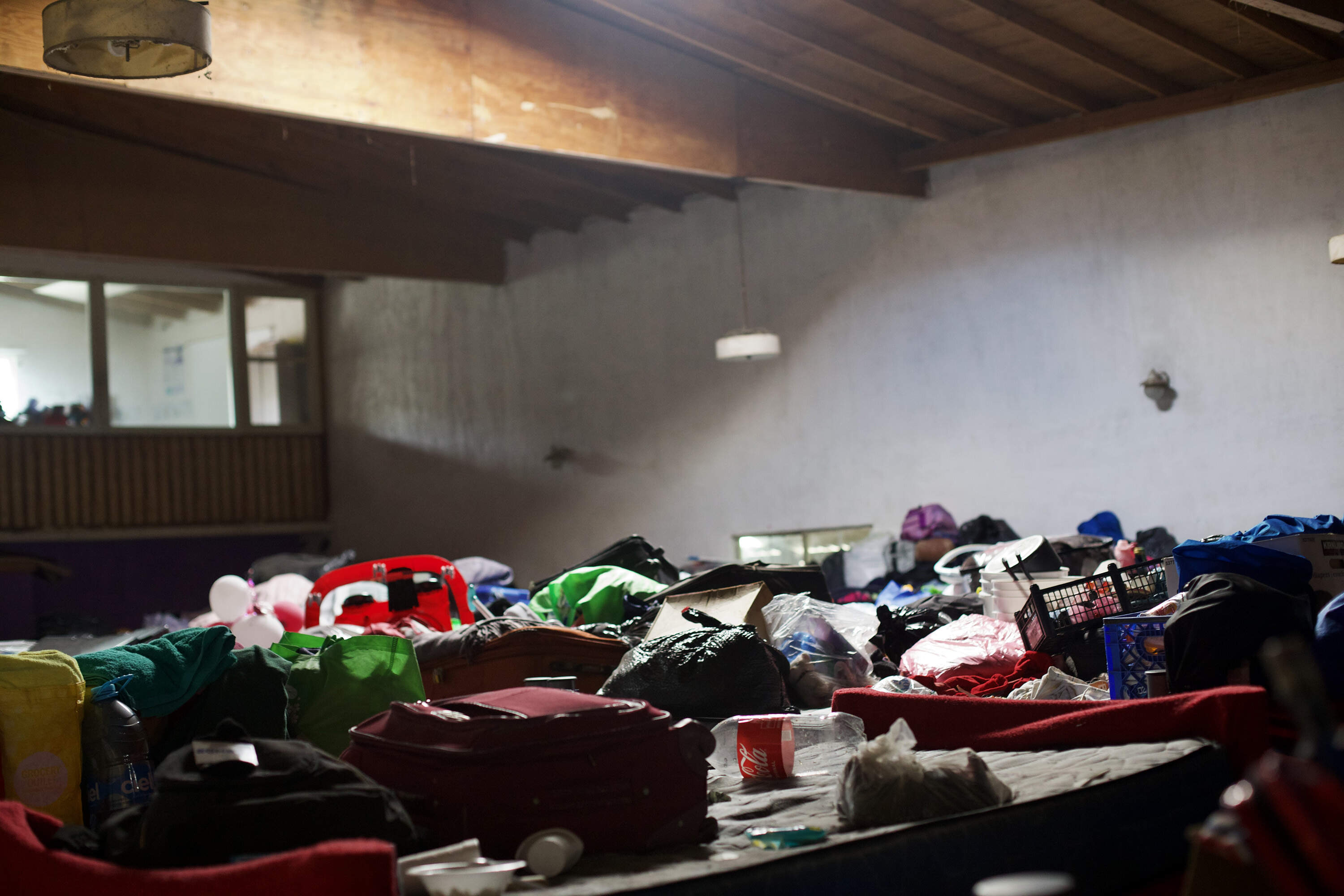 Belongings are stored on top of rows of bunk beds at one of Tijuana's largest homeless shelters. (Zenobia Pellissier Lloyd for WBUR)