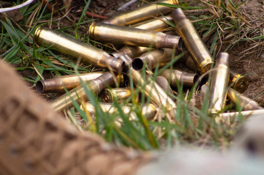 Brass shell casings for the .50 caliber machine gun, informally known as “Ma Deuce.” Many Massachusetts soldiers must travel to Vermont to qualify with the weapon. (Elodie Reed/Vermont Public)