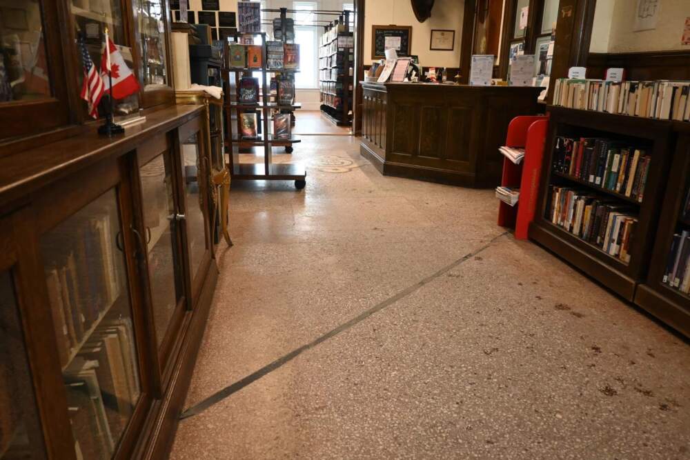 A line on the floor of the Haskell Free Library and Opera House shows where the building bisects the border between Derby Line, Vermont, and Stanstead, Quebec, on Friday, Feb. 28. (Catherine Morrissey/Vermont Public)