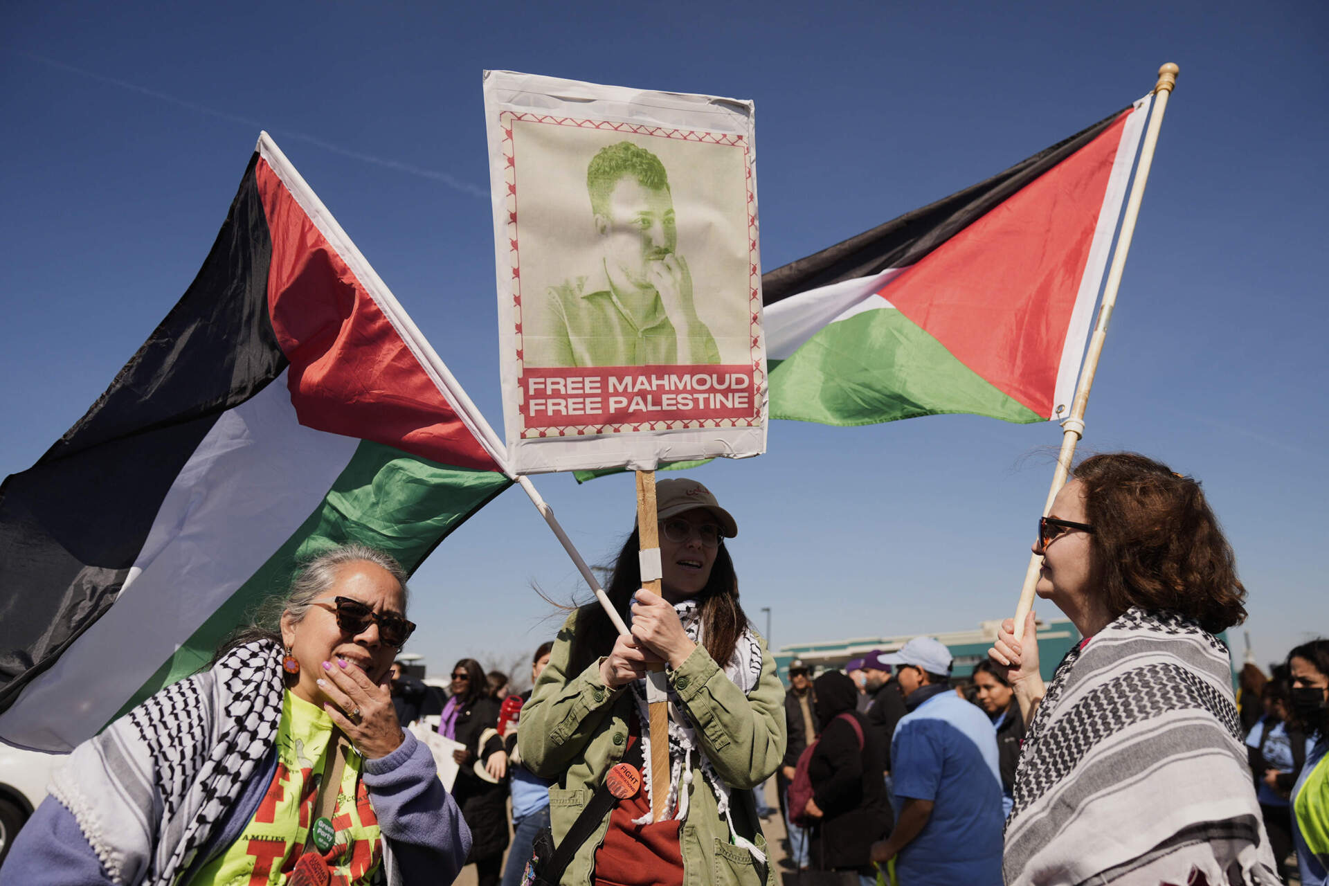 Protesters hold a sign for Mahmoud Khalil in Newark, N.J. on Tuesday. The protest was held in front of Delaney Hall, the proposed site of an immigrant detention center. (Seth Wenig/AP)