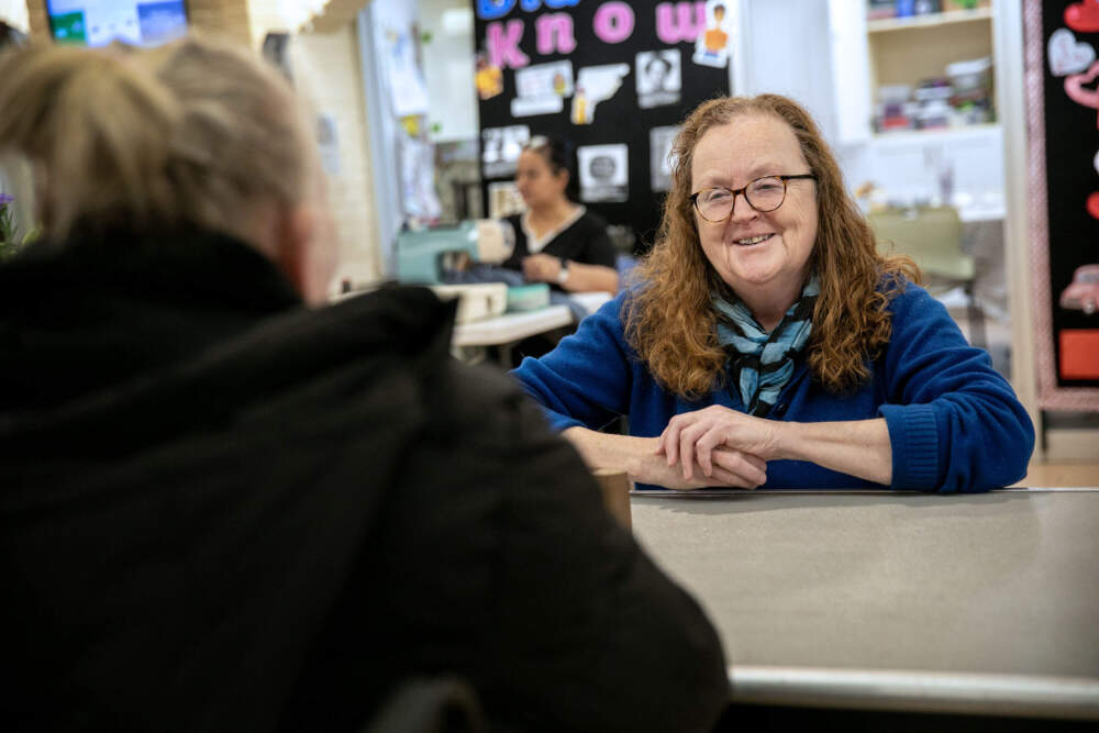 Dr. Eileen Reilly, who co-founded Women's Lunch Place in Boston in 1982, talks with a shelter guest. (Robin Lubbock/WBUR)