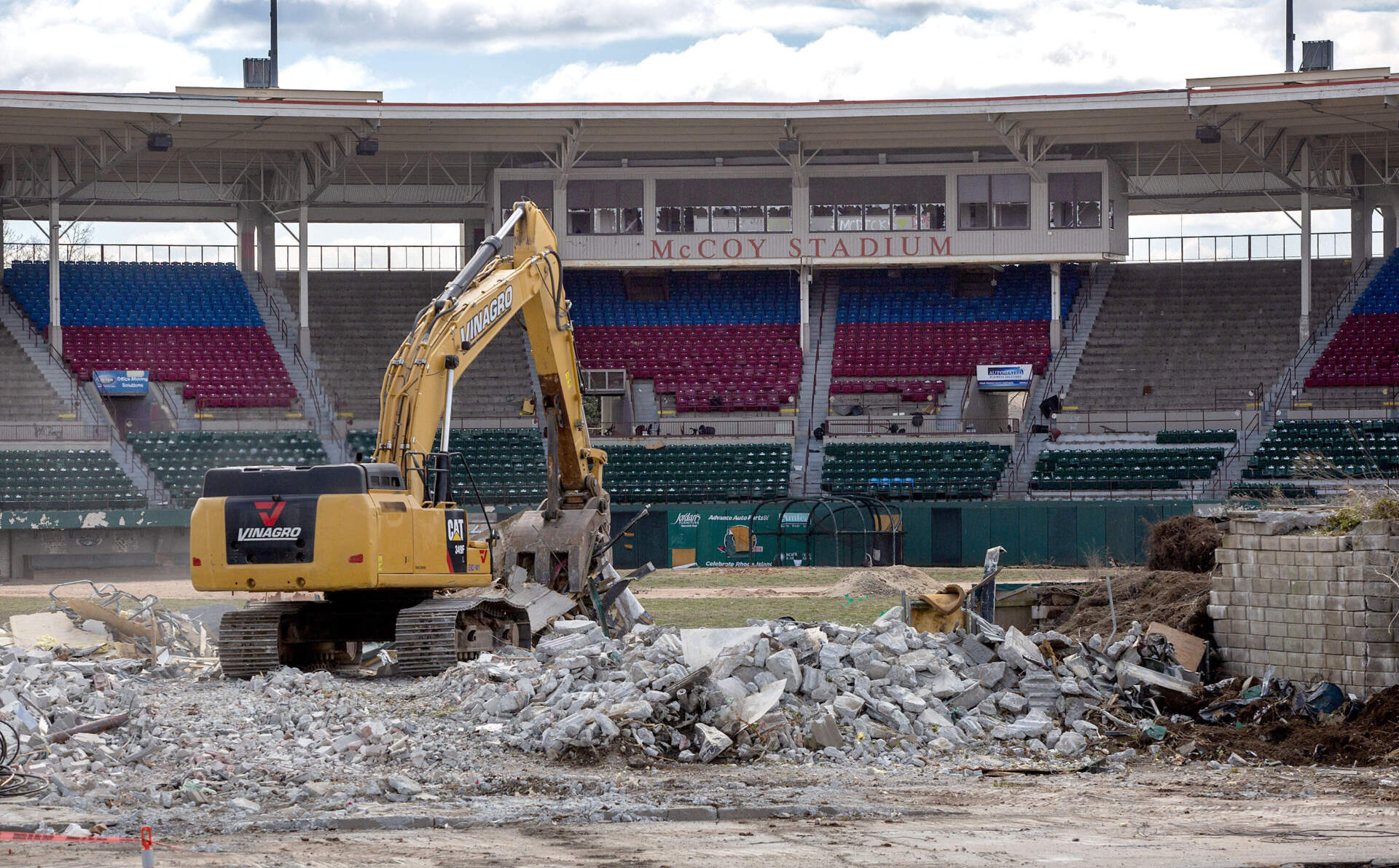 An excavator moves rubble at McCoy Stadium. (Robin Lubbock/WBUR)