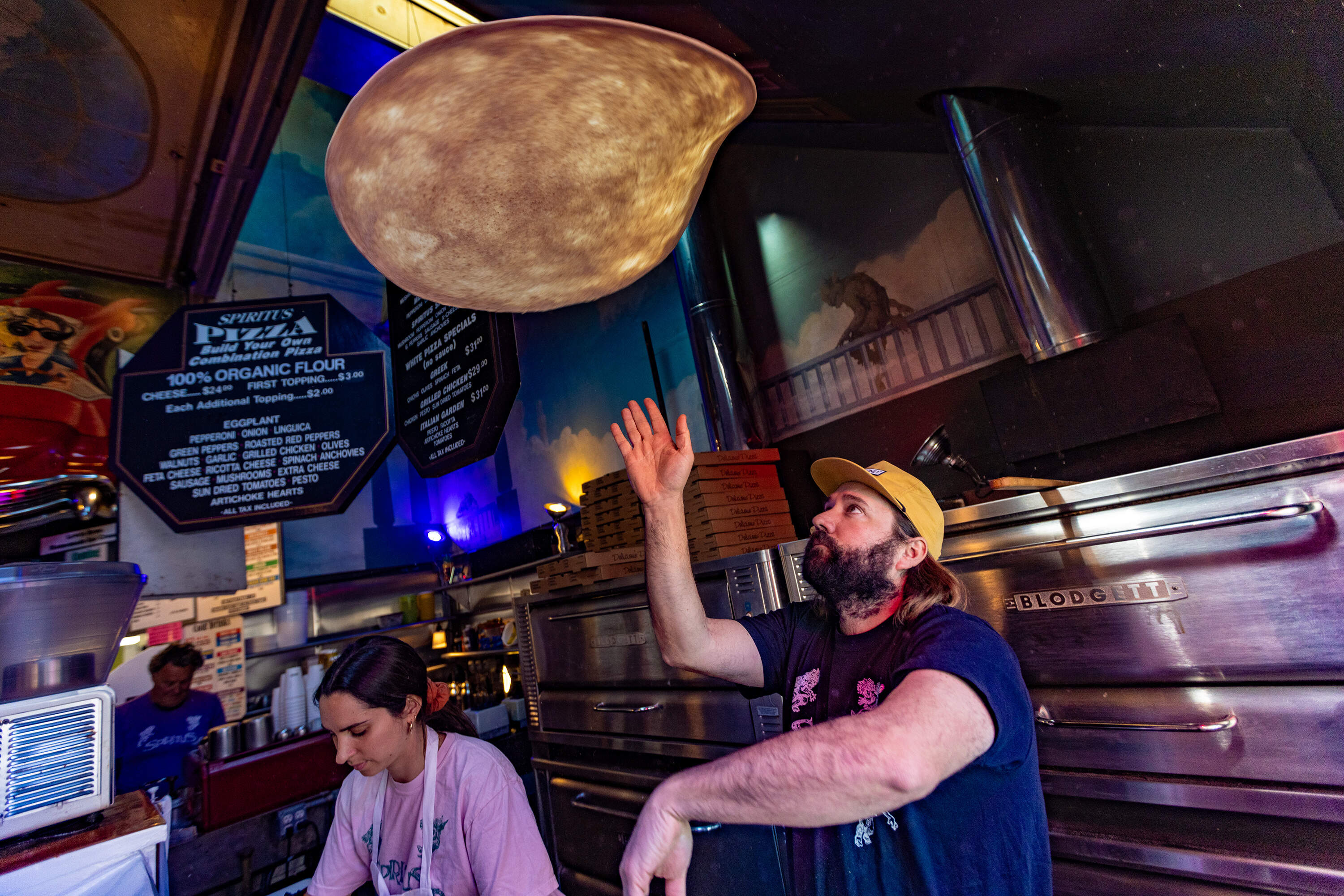 Co-owner Guillermo Yingling spins dough into the air on opening day of the spring season at Spiritus Pizza in Provincetown. (Jesse Costa/WBUR)