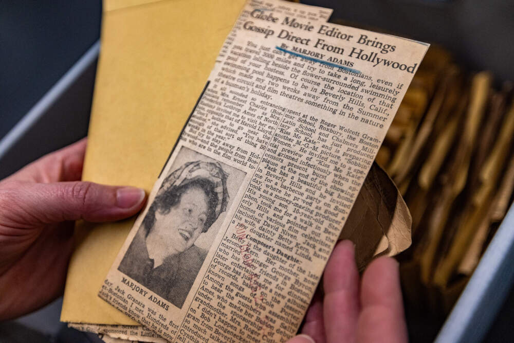 The author holds an article by Boston Globe film critic Marjory Adams at the Snell Library at Northeastern University. (Jesse Costa/WBUR)