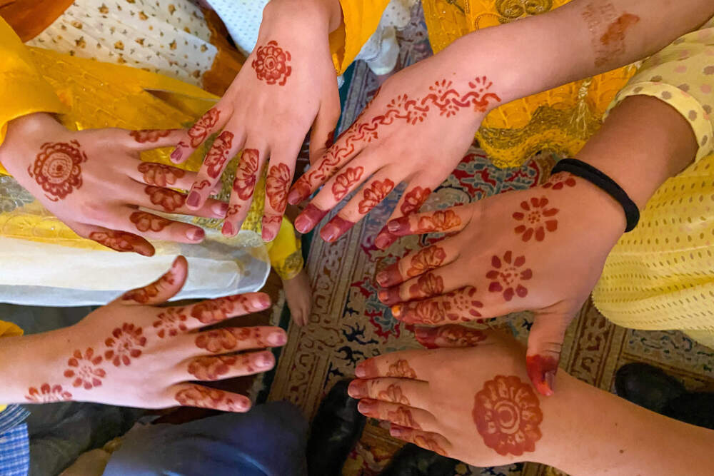 Afghan girls show the henna applied on their hands as part of a recent celebration of Eid, the end of the Muslim holy month of Ramadan. (Deborah Becker/WBUR)