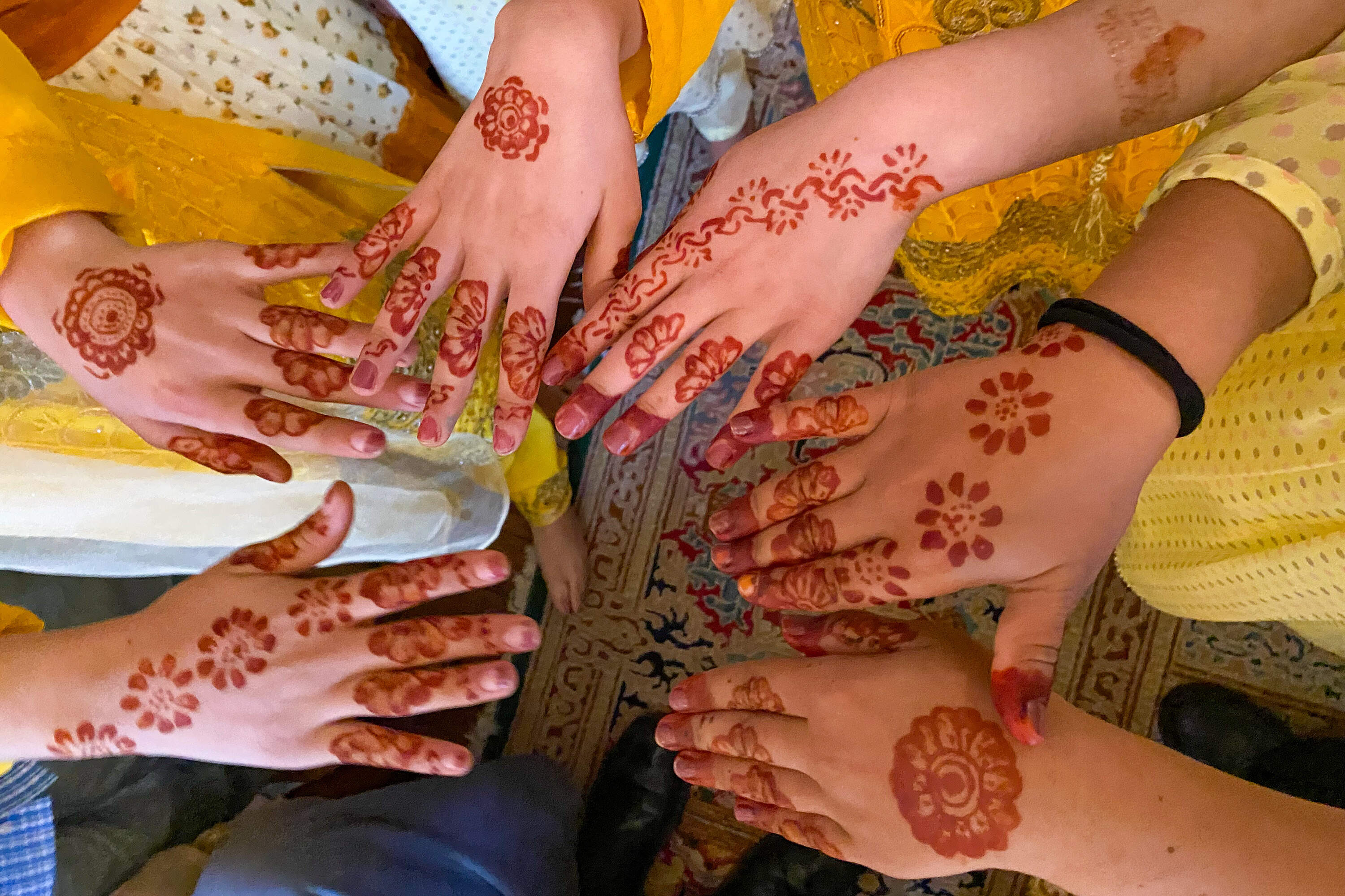 Afghan girls show the henna applied on their hands as part of a recent celebration of Eid, the end of the Muslim holy month of Ramadan. (Deborah Becker/WBUR)