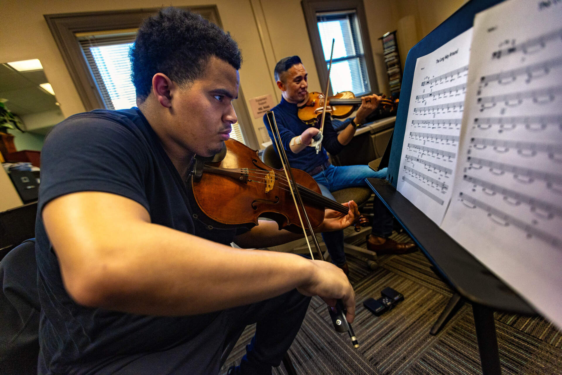 Violist Connor Valcy and Associate Professor Adrian Anantawan rehearse with the Music Inclusion Ensemble at the Berklee College of Music. (Jesse Costa/WBUR)