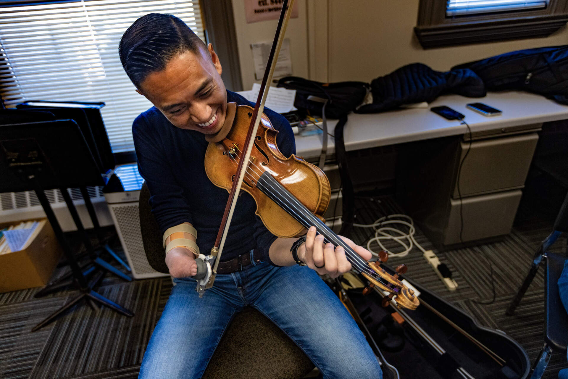 Associate Professor Adrian Anantawan plays violin with the Music Inclusion Ensemble during a rehearsal at the Berklee College of Music. (Jesse Costa/WBUR)