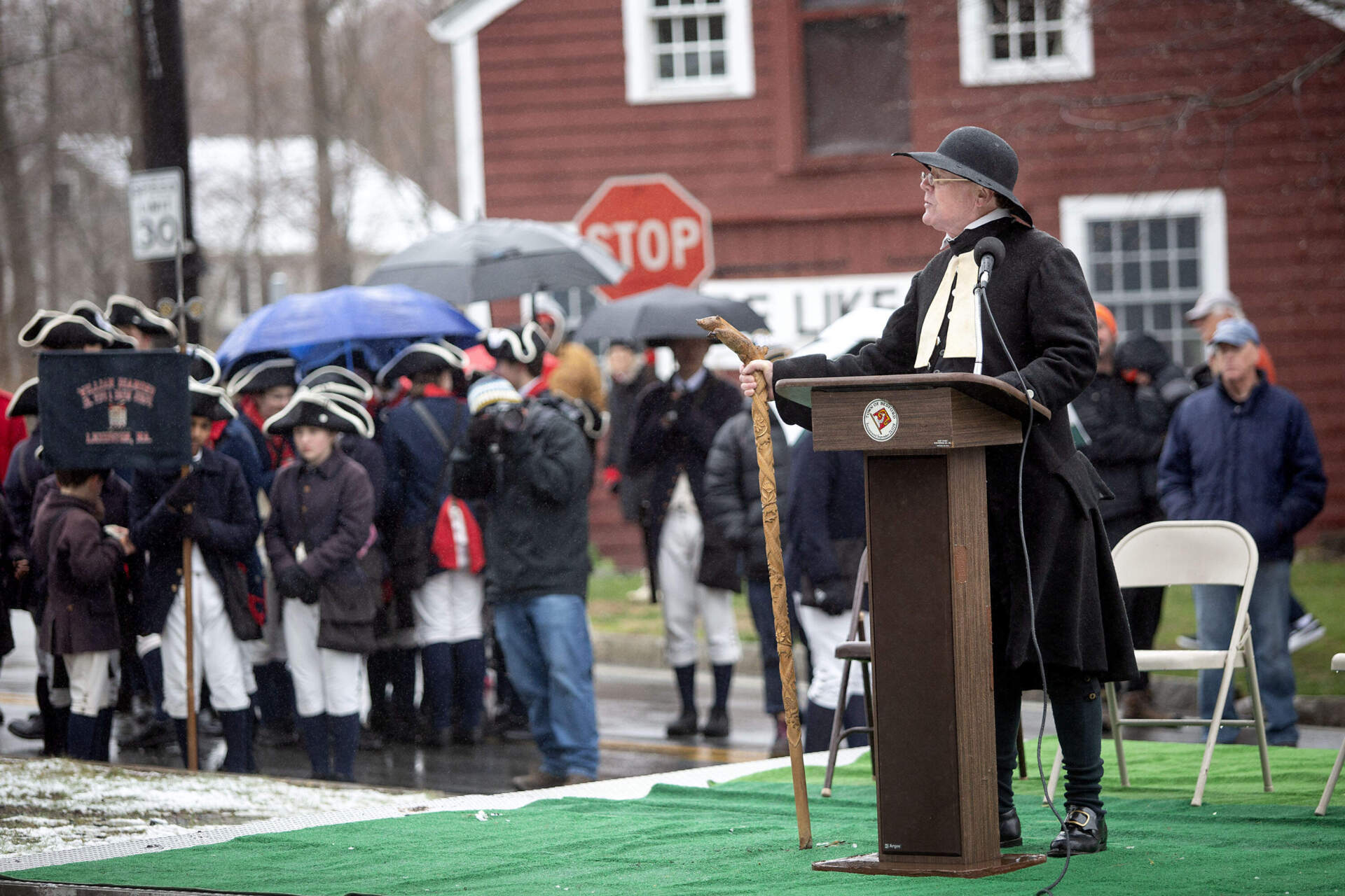 Rev. John Eric Gibbons talks to Minutemen and onlookers at a gathering of Minutemen at Wilson Park in Bedford, Mass. (Robin Lubbock/WBUR)