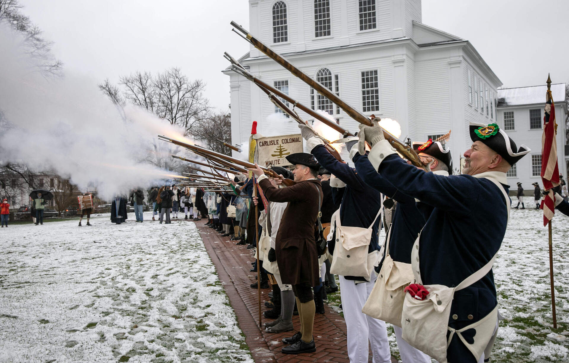 Minutemen fire their muskets on Bedford Town Common, Mass. (Robin Lubbock/WBUR)