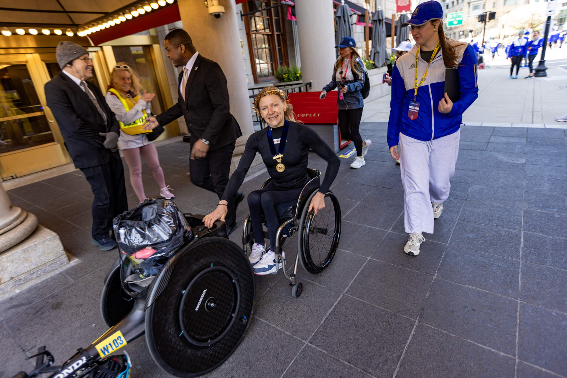 Women’s wheelchair winner Susannah Scaroni of the United States heads to the post-race press conference at the Fairmont Hotel. (Jesse Costa/WBUR)