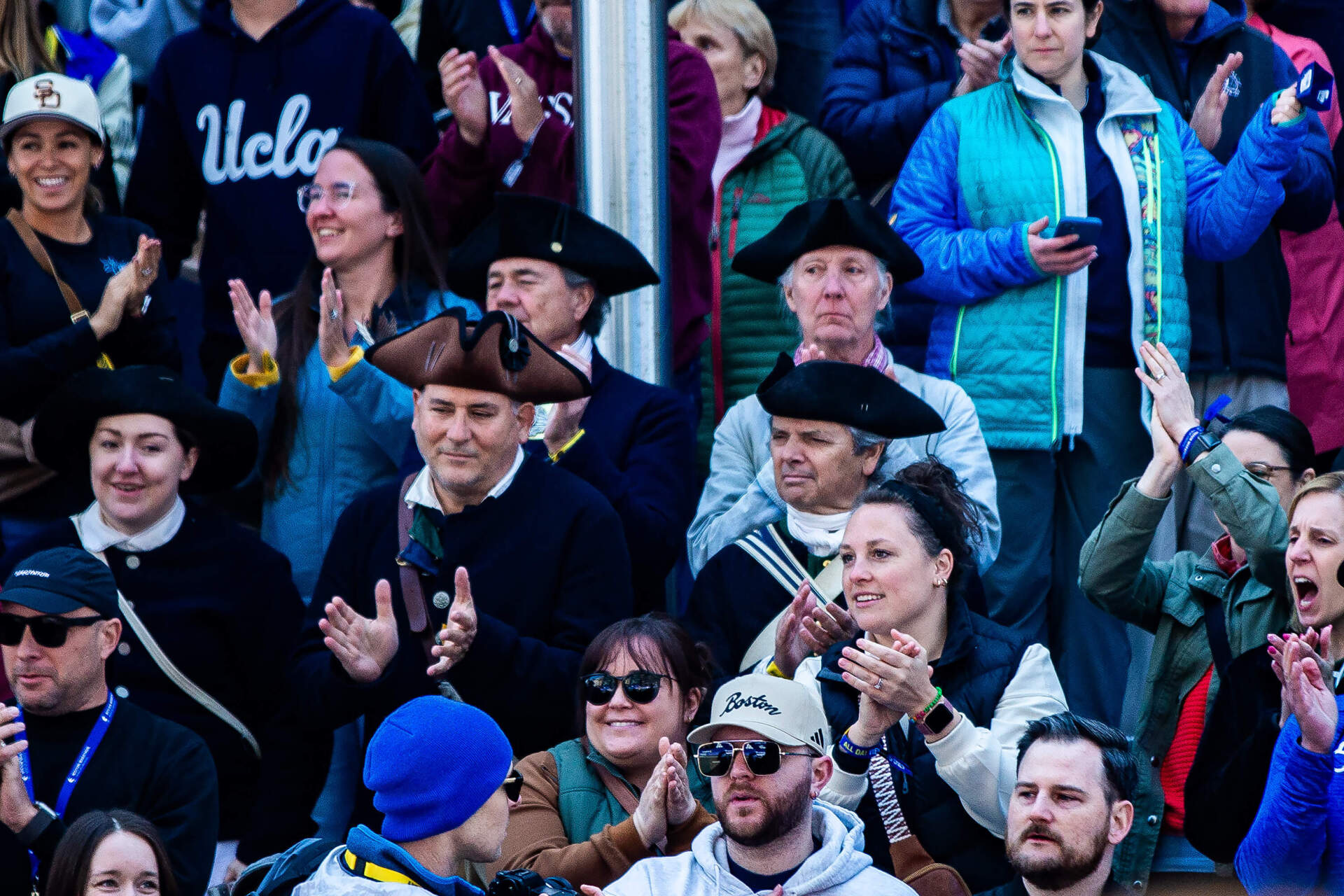 Spectators dressed as Minutemen cheer for runners from the grandstand at the finish line at the Boston Marathon. (Jesse Costa/WBUR)