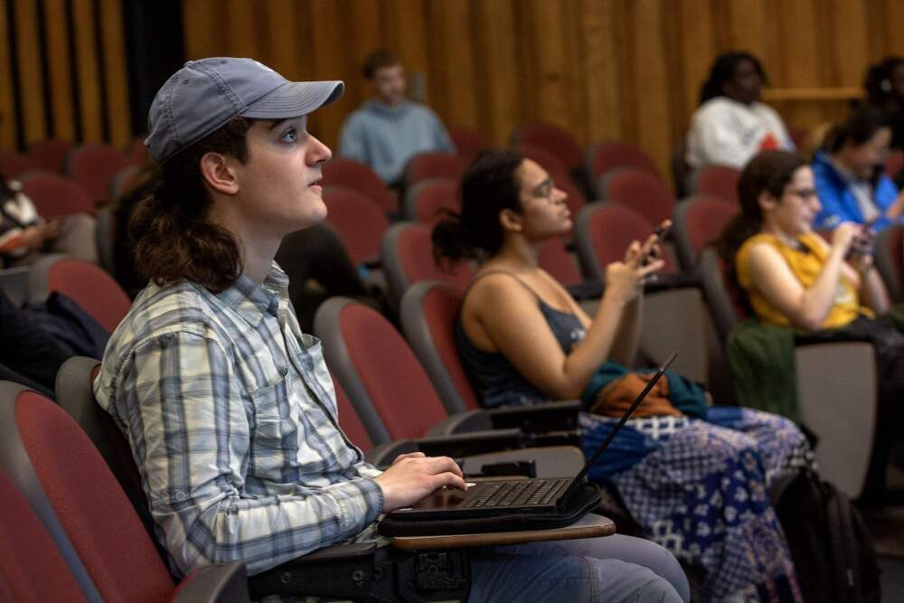 Thomas O'Connor Golden looks up at the screen during a conservation biology class at Brandeis University. (Robin Lubbock/WBUR)