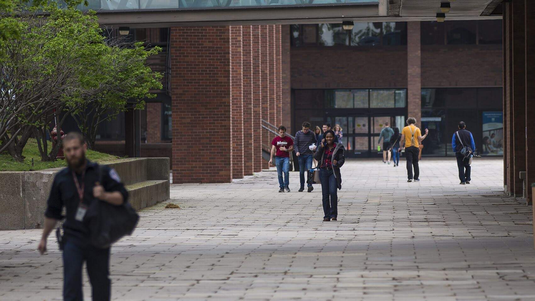 People walking through UMass Boston's campus in 2018. (Jesse Costa/WBUR)