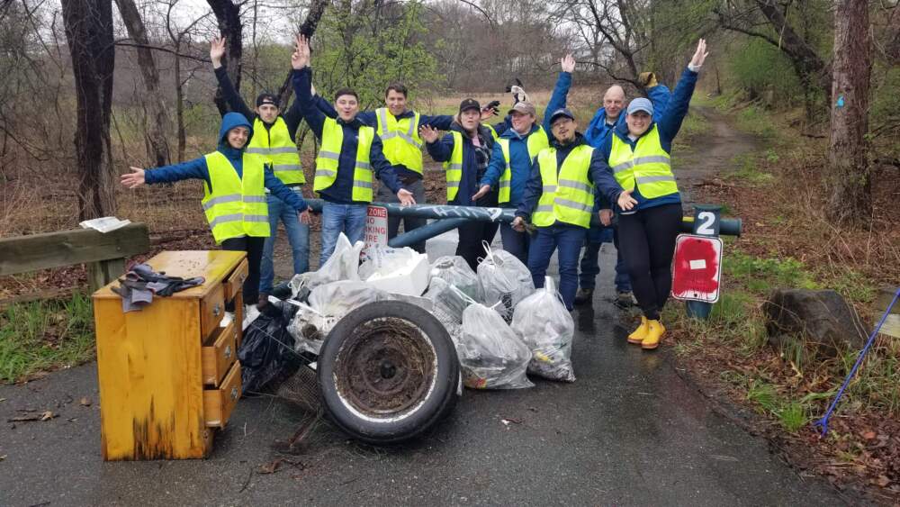 Volunteers with the Charles River annual cleanup pose with the trash they've collected. (Photo courtesy of the Charles River Watershed Association)