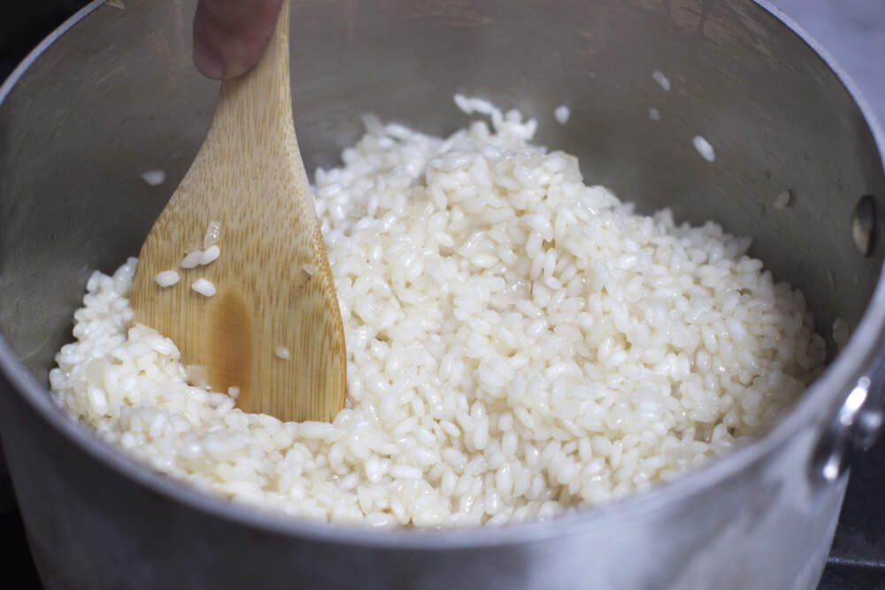 Broth is stirred into risotto rice. (Matthew Mead/AP)