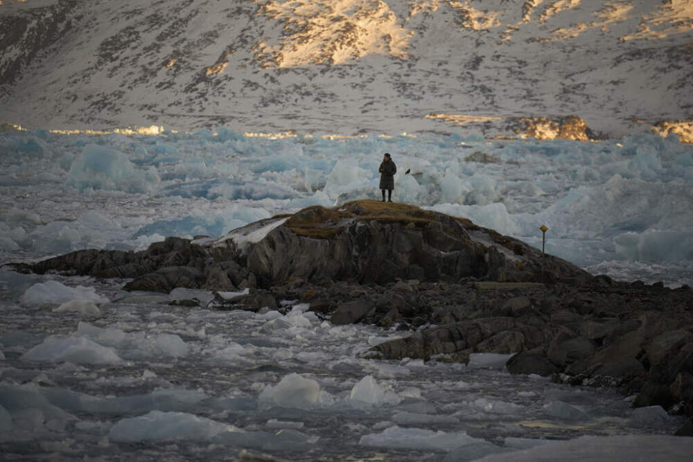 A resident watches as pieces of ice pile up, blocking the access of the port of Nuuk, Greenland, on Tuesday, Feb. 18, 2025. (Emilio Morenatti/AP)