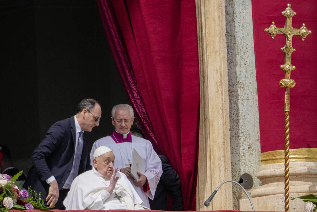 Pope Francis appears on the central lodge of St. Peter's Basilica to bestow the Urbi et Orbi (Latin for to the city and the world) blessing at the end of the Easter mass presided over by Cardinal Angelo Comastri in St. Peter's Square at the Vatican Sunday, April 20, 2025. (AP Photo/Gregorio Borgia)