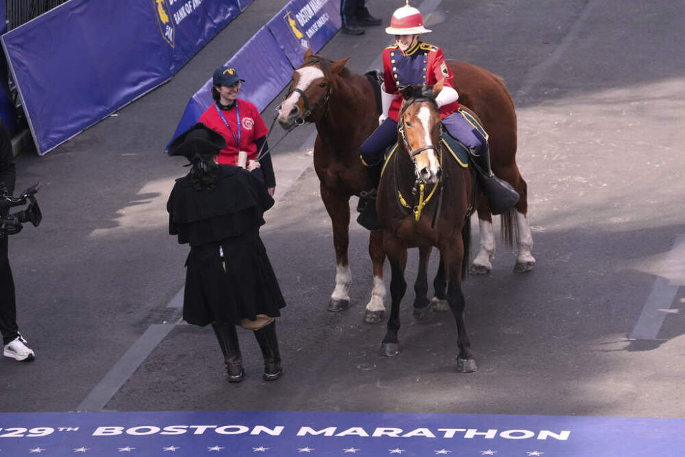 An actor portraying Paul Revere tries to pull his horse, which refused to advance over the line, during the ceremony Monday morning in Boston. (Charles Krupa/AP)
