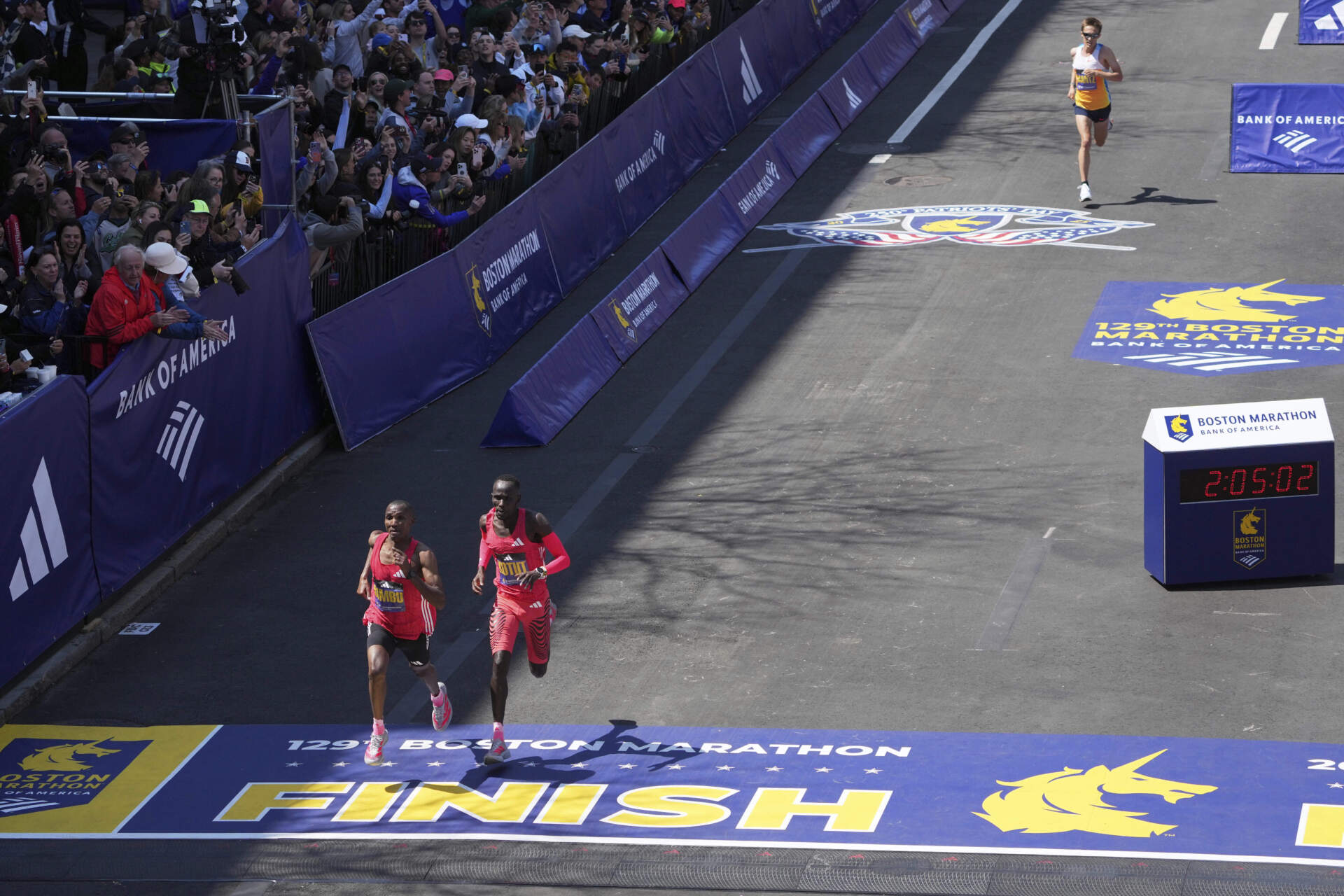 Alphonce Felix Simbu, left, and Cybrian Kotut sprint for second towards the finish line. Conner Mantz, of the United States, top right, chases behind. (Charles Krupa/AP)