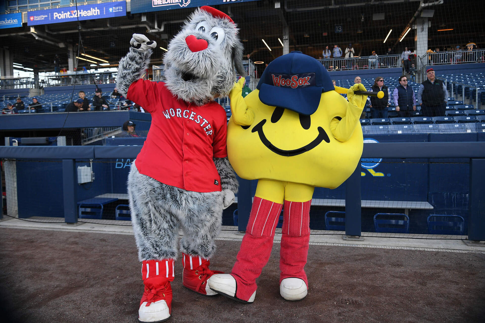 Woofster (left), the official rescue dog of WooSox mascot Smiley Ball (right) poses for a photo with Smiley Ball prior to a Worcester Red Sox game on April 27, 2023, at Polar Park. (Erica Denhoff/Icon Sportswire via Getty Images)