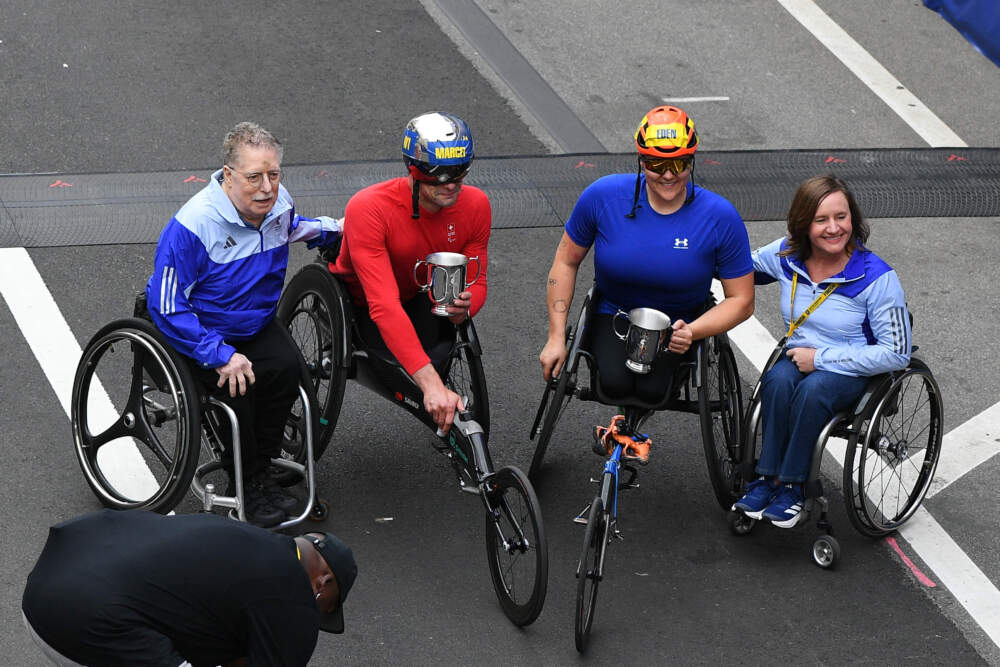 Bob Hall (Boston Marathon's first official wheelchair athlete), Marcel Hug of Switzerland, Eden Rainbow-Cooper of Great Britain, and Dr. Cheri Blauwet pose for a photo after Hug and Rainbow-Cooper won the men's wheelchair and women's wheelchair divisions of the Boston 5K on April 19, 2025, in Boston. (Erica Denhoff/Icon Sportswire via Getty Images)