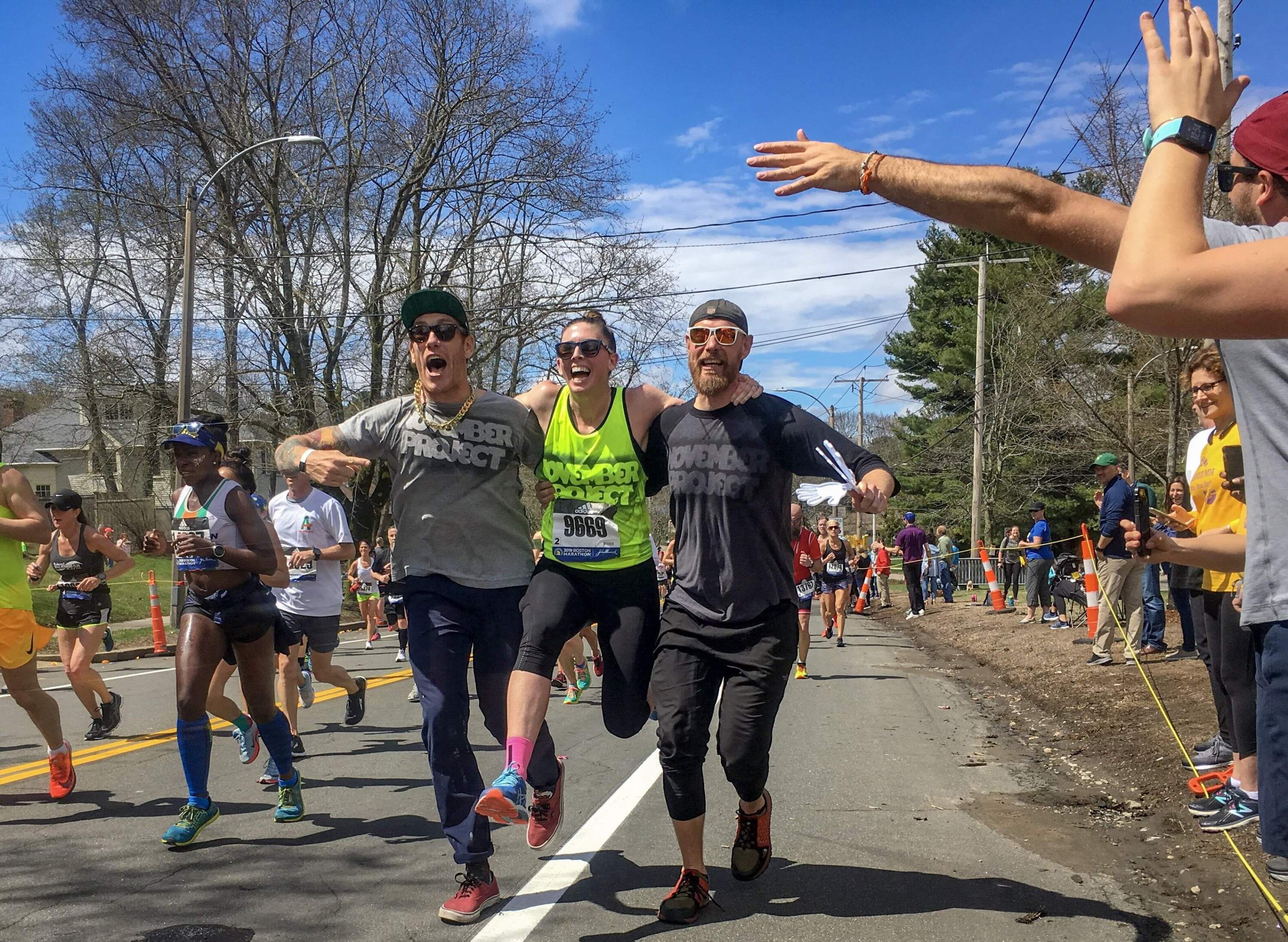 Laura Green, giving her legs a quick break with the help of friends Brogan Graham and Bojan Mandari during the 2019 Boston Marathon. (Courtesy Laura Green)