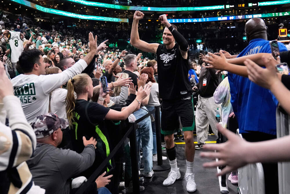Boston Celtics center Kristaps Porzingis celebrates with fans after eliminating the Orlando Magic in Boston. (Charles Krupa/AP)